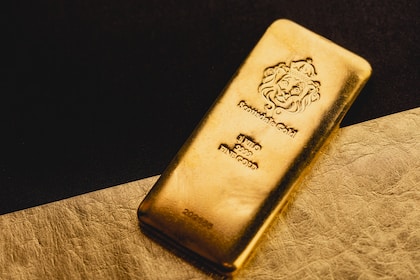 a gold bar sitting on top of a piece of paper